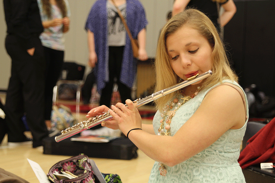 Before playing for a judge, senior Grace Sulzman practices her quartet piece for the state band competition on Saturday, April 25.