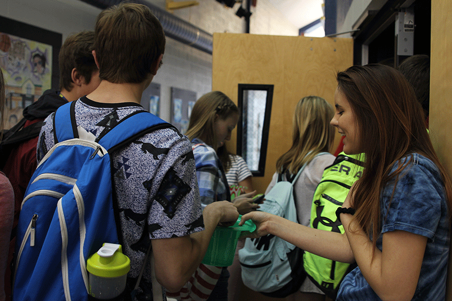 Junior Dani Stompoly accepts tickets at the door for those who attend the film fest during seminar.