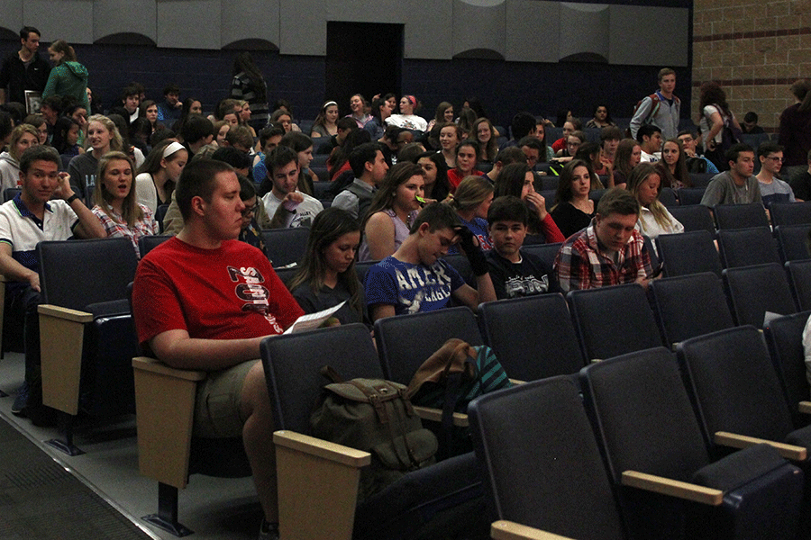 Students gather in the little theater and wait for the first film to begin.