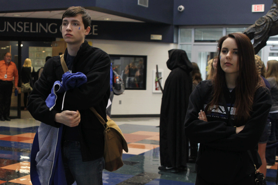 Senior Jack Earlenbaugh and junior Dani Stompoly stand in the foyer as part of the campaign for Distracted Driving Awareness.