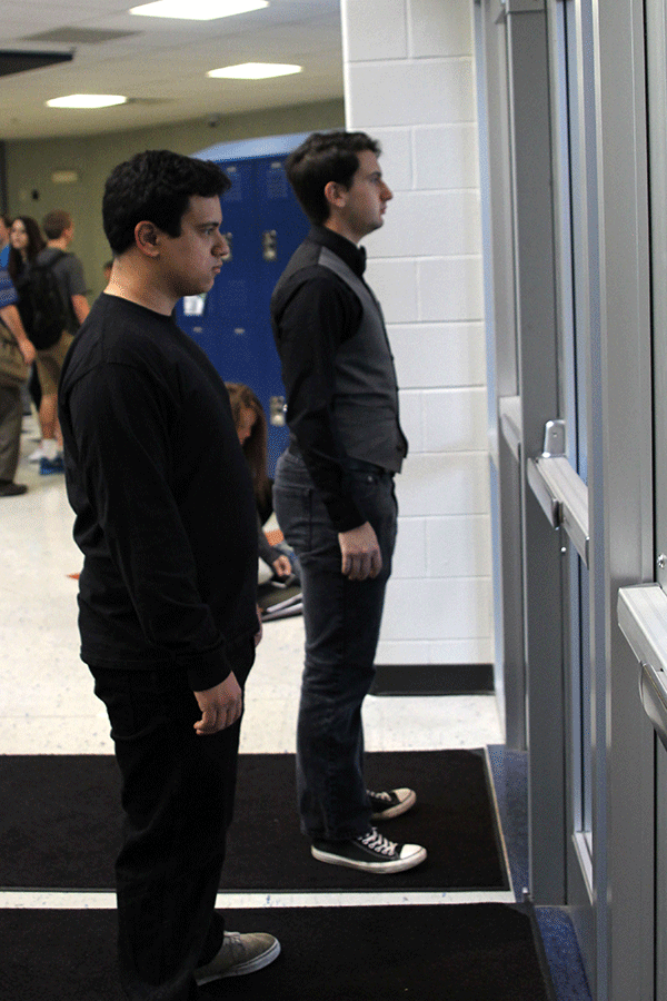 Senior Adam Segura and Austin Moore stand at the main entrance warning students about the dangers of distracted driving.