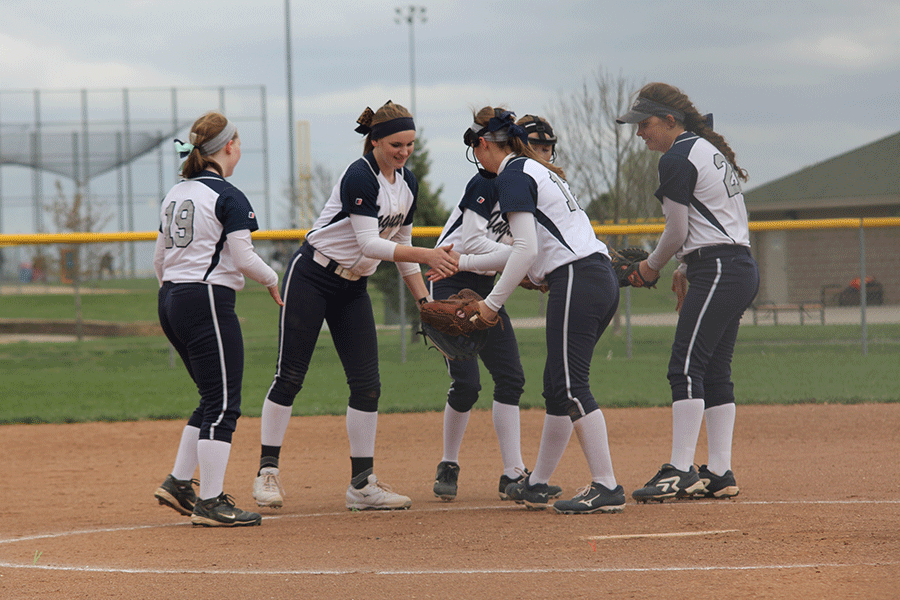Senior Kaitlin Parker and sophomore Kristen Kelly do a handshake to start off the game against Basehor-Linwood on Thursday, April 9. The Jaguars defeated the Bobcats 12-1 in the first game, and fell 5-2 in the second.