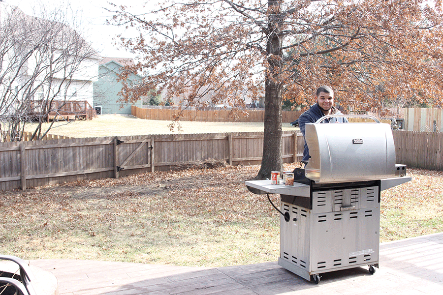 Preparing for his next competition, junior Anthony Brown seasons and smokes meat on Friday, Jan. 13.     