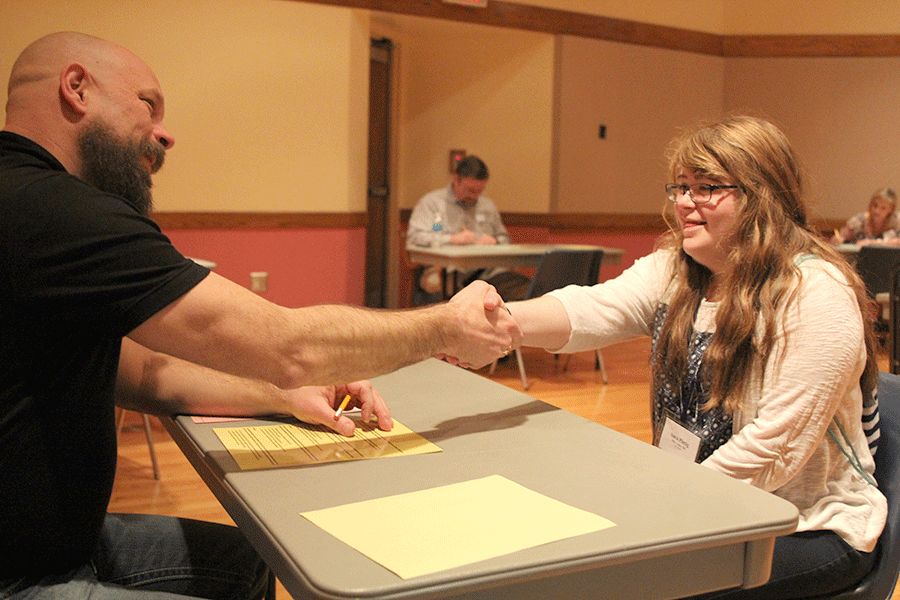 At the completion of her event, junior Sara Pietig shakes the judges hand.