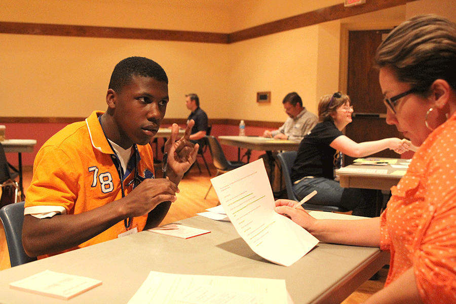 Competing in the role-play event, freshman Malik Redmond imitates taking a phone message. Redmond placed third among all freshman at the Job Olympics.
