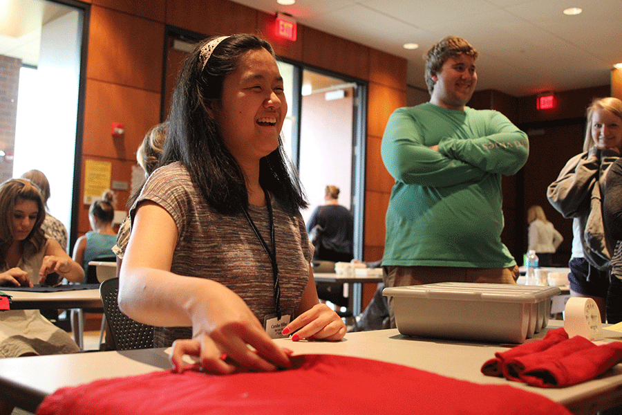 At the completion of the folding silverware event, junior Caroline Miller laughs. Miller placed third out of all juniors in the event.