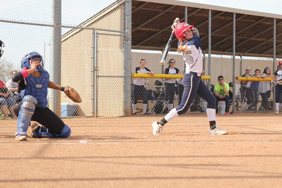 Sophomore Kristen Kelly watches her ball fly out of bounds on Thursday, April 15 against Blue Valley Northwest. 