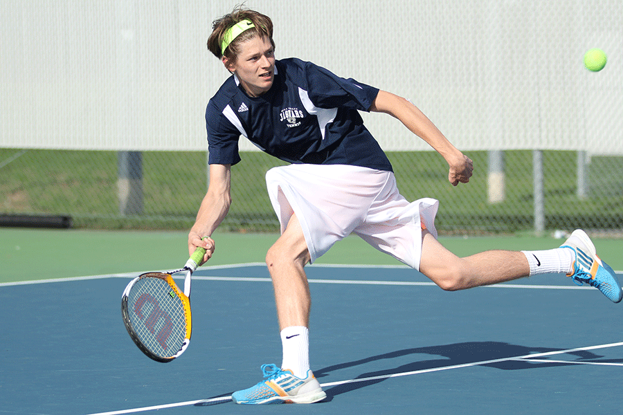 Racing the ball across the court, sophomore Jansen McCabe reaches to return the ball.