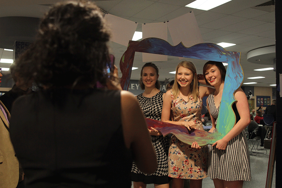 Grinning for a picture, juniors Hannah Schrepfer, Riley Wagner, and Audrey Linsey hold up a frame at the first annual drama banquet on Friday, April 20.