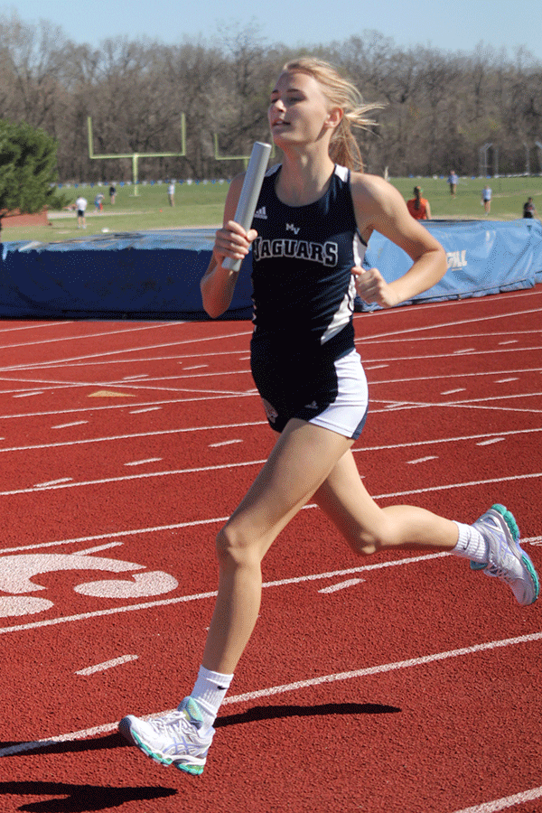 Freshman Bella Hadden runs in a relay race on Tuesday, March 31.