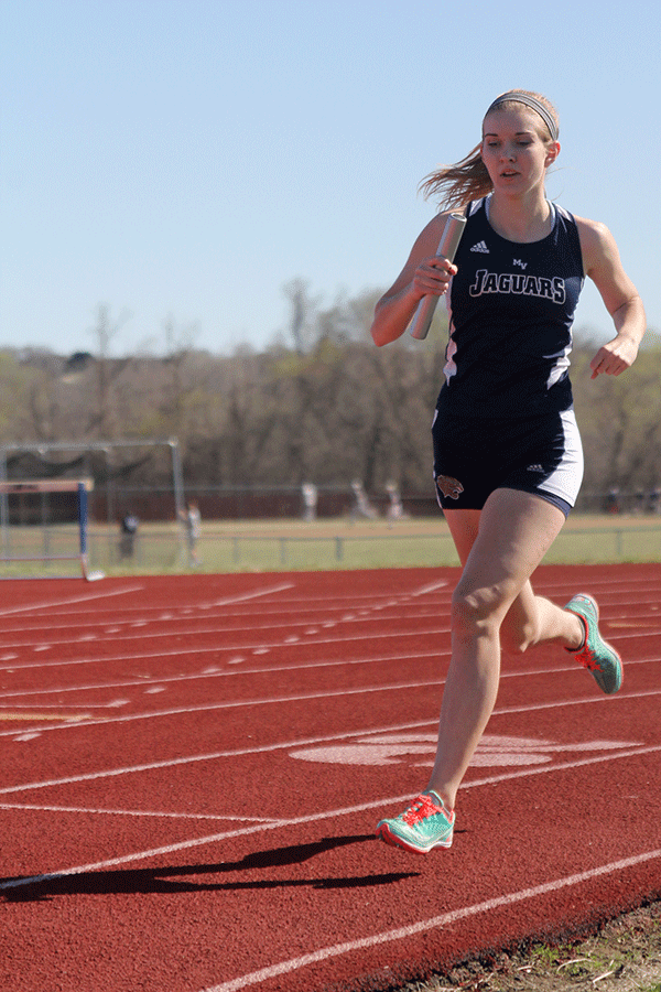 Junior Amber Akin runs in a relay race on Tuesday, March 31.