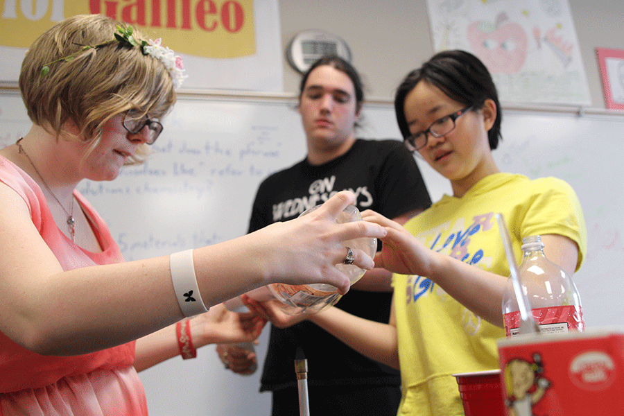 Senior Chari Pierce, junior Jordan Wootton and junior T-Ying Lin work together to melt a soda bottle on Wednesday, April 1.
