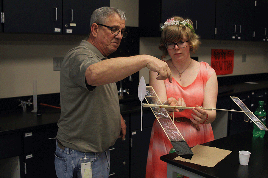 On Wednesday, April 1, assistant coach Mike Pierce and senior Chari Pierce discuss the mechanics of their plane.  