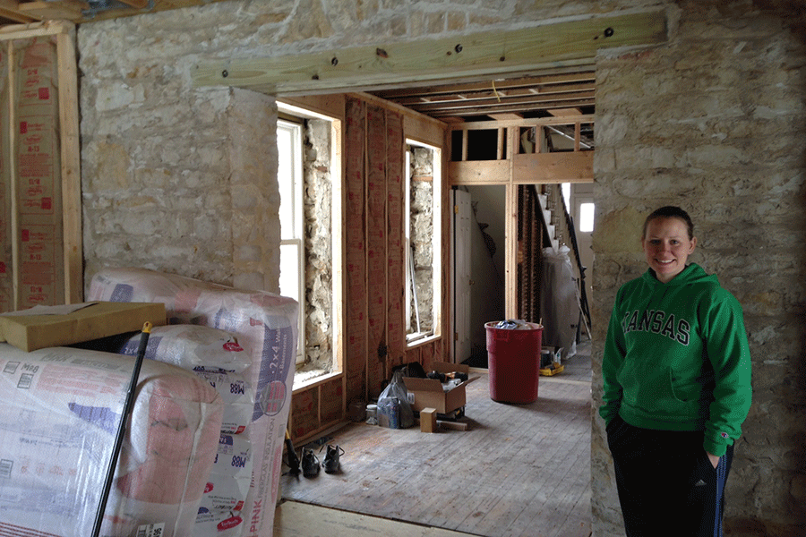 In her newly-bought home in Lawrence, math teacher Lindsey Weiland stands in her unfinished kitchen on Monday, March 2.