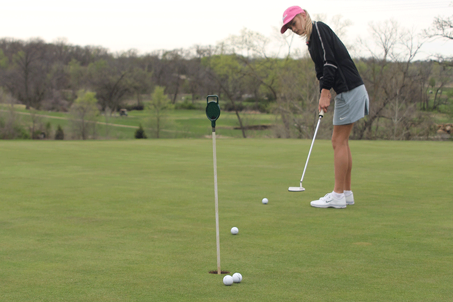 Freshman Bella Hadden puts the ball at the Shawnee Golf and Country Club on Monday, April 13. “[My favorite part is] putting and chipping,” Bella said. “It’s more important to the game when you’re closer to the hole.”