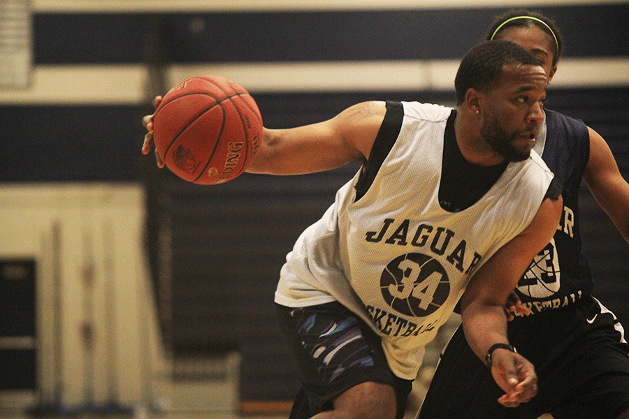 While looking for an open pass, Coach Geoff White takes the ball down the court during the student v. faculty game on Tuesday April, 28.                                                                                                                                                 