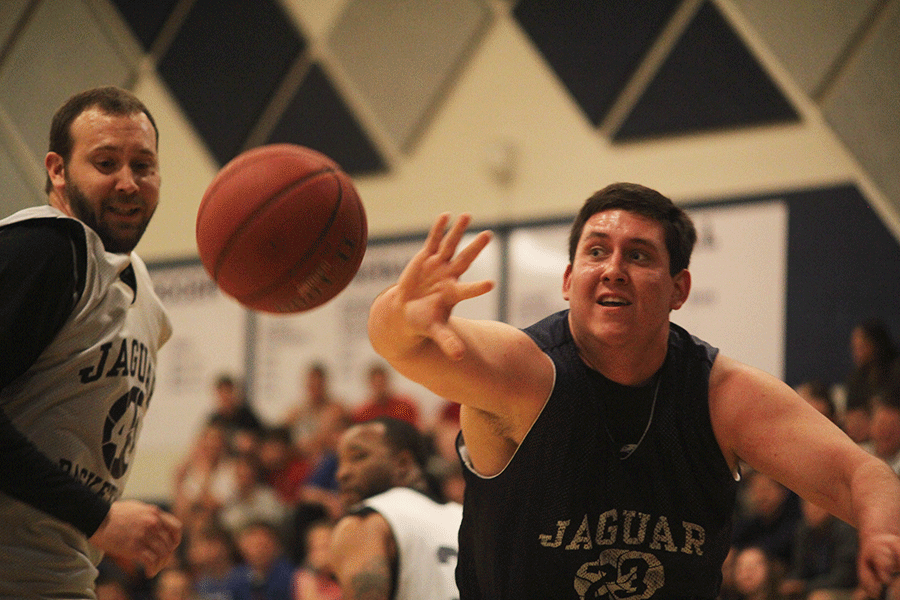 Hand open wide, Senior Evan Applegate attempts to block the ball from the faculty team during the student v. faculty game on Tuesday, April 28. 