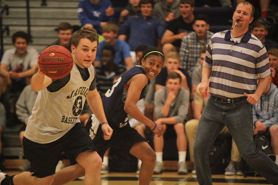 To help out his faculty team, para professional Ian Nichols dribbles the ball down the court during the student v. faculty game on Tuesday April, 28. 