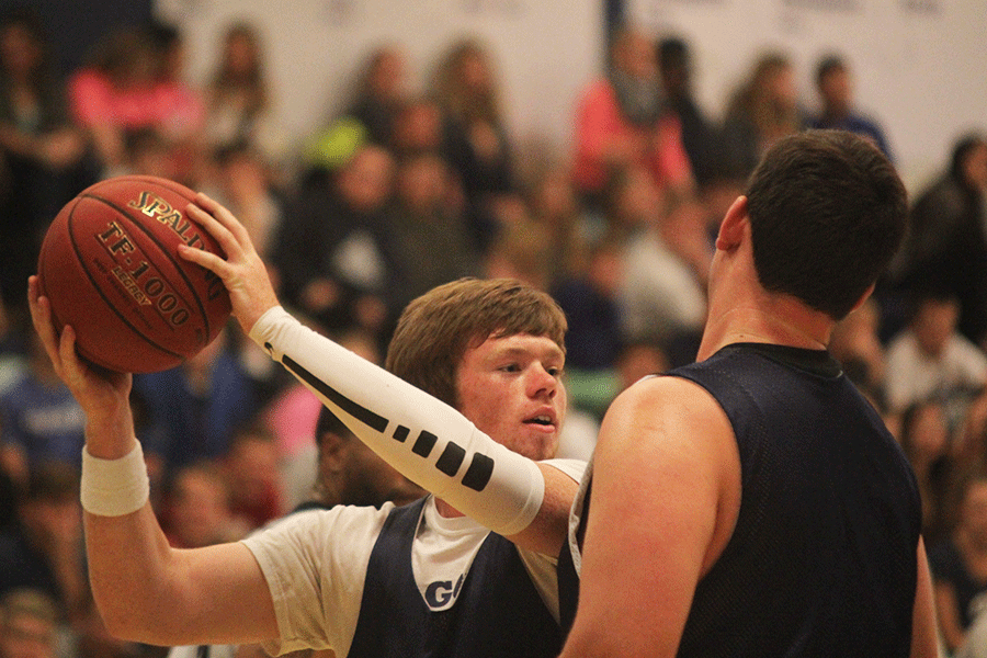 Ball in hand, senior Conner Kaifes looks for someone to pass to during the student v. faculty game on Tuesday April, 28. 