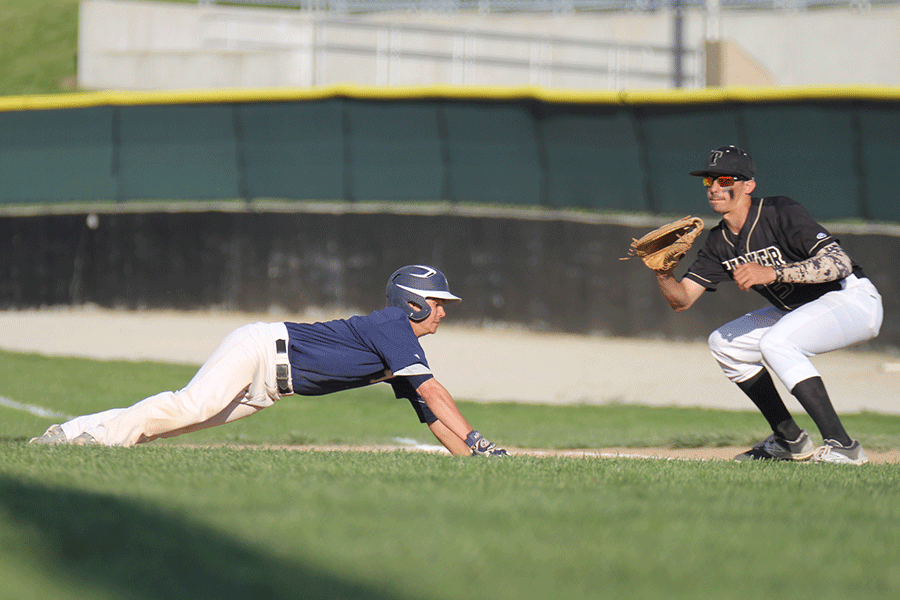 In the second game against Turner on Thursday, April 30 junior AJ Knight slides into first to avoid being picked off.