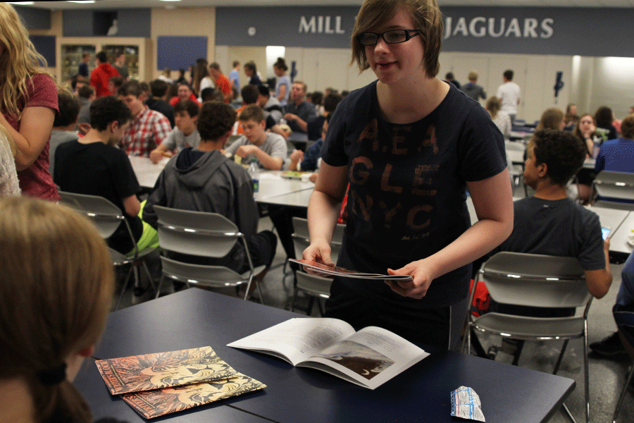 Senior Brooke Drescher buys her copies of the Literary Magazine on Friday, May 1.