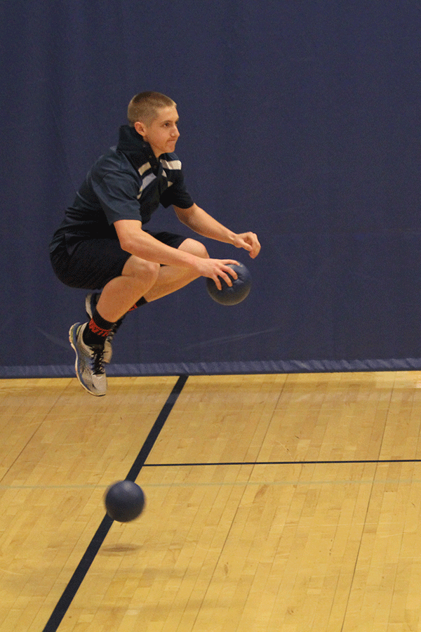 Senior Austin Dyche jumps to dodge a ball.