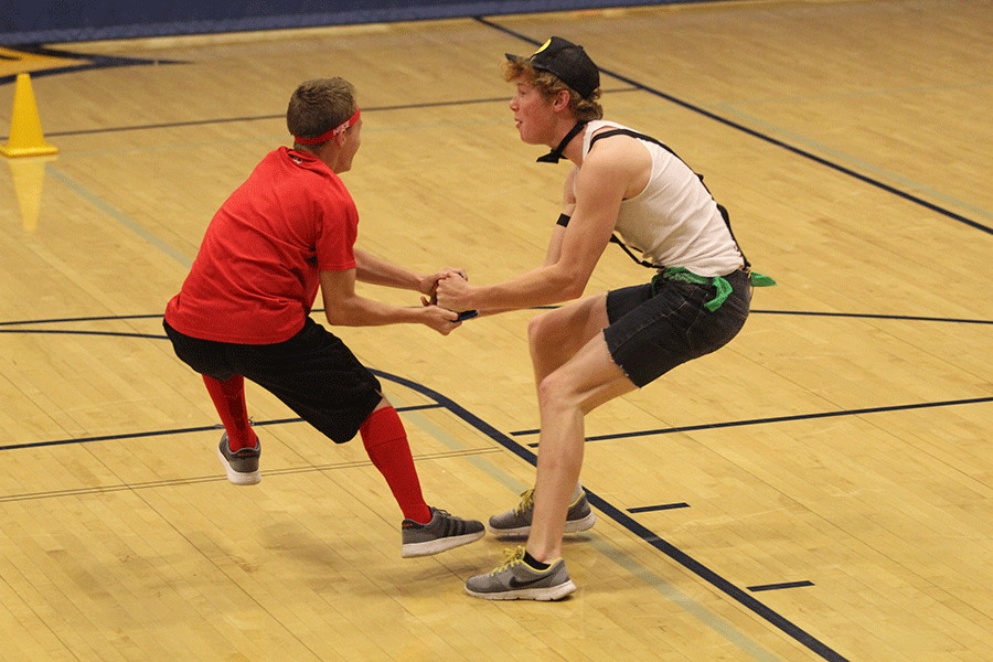 At the start of the match members from two separate teams fight over a ball.