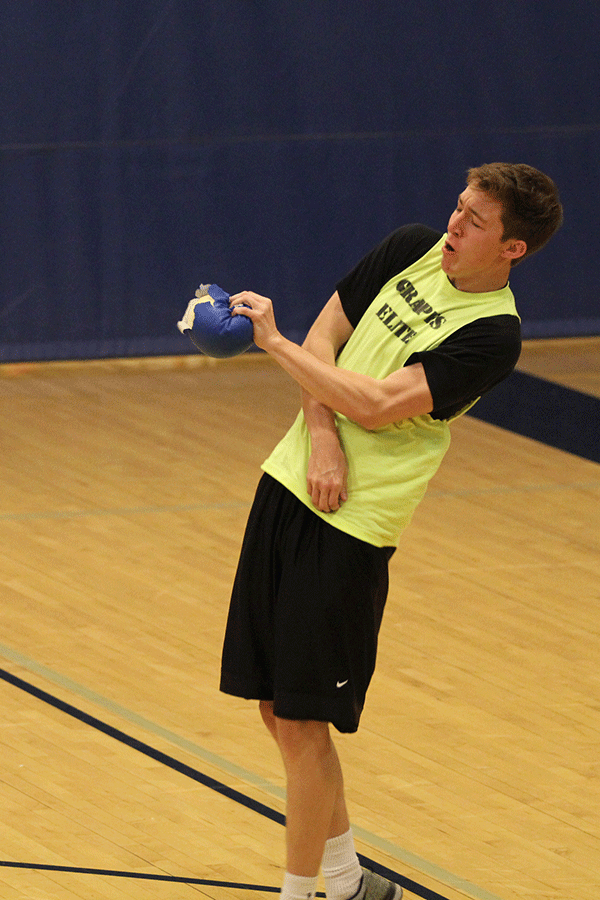 To stay in the match, junior Jacob Klenda catches a dodgeball.