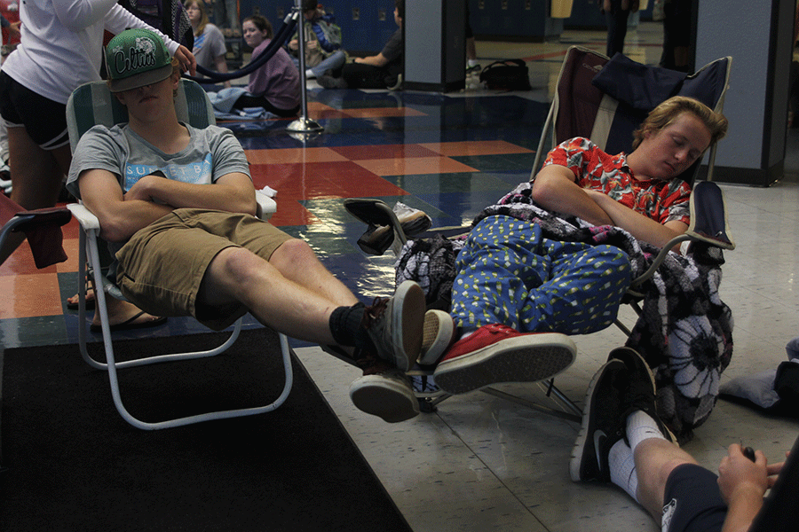 Seniors Spencer Adams and Collin Vinson remain asleep at the front doors on Monday, May 18 for the senior prank. 