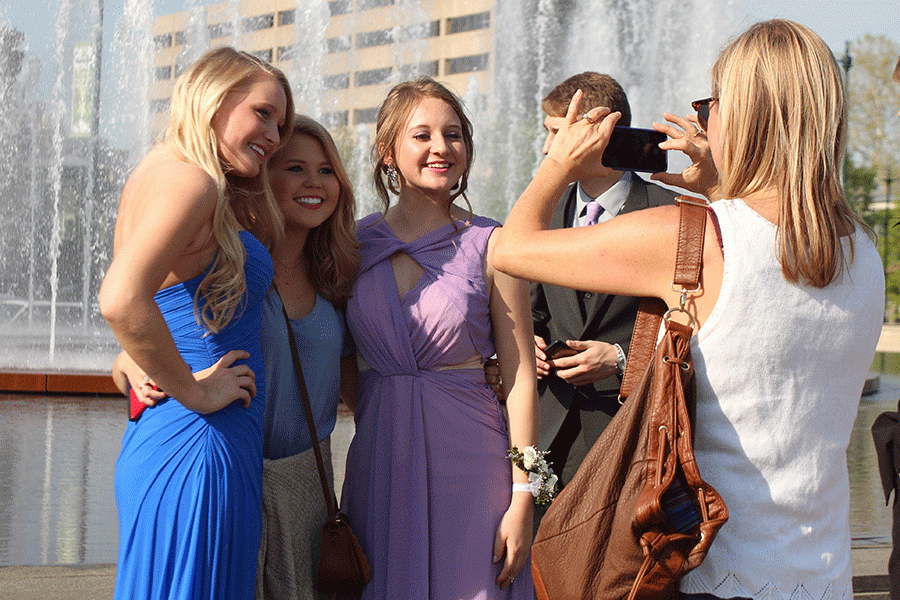 Before the dance, seniors Hannah Rust and Tara Kretzchmar pose for a prom photograph. 