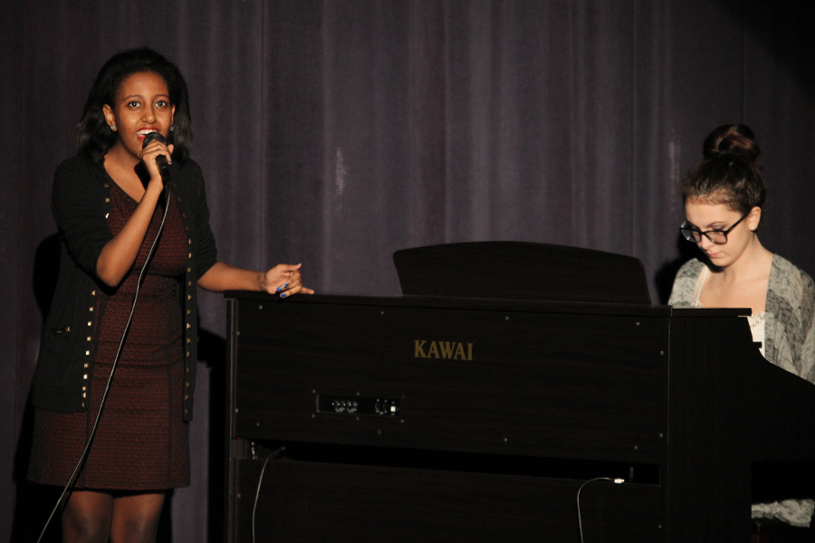 Junior Helina Mekonnen sings a solo as junior Kelly Gothard accompanies it.