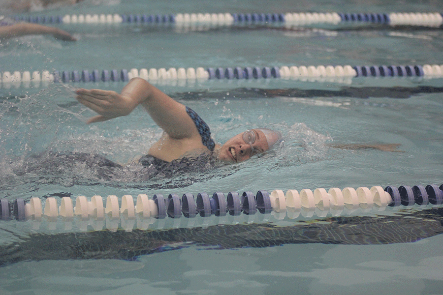 While swimming freestyle, sophomore Maddie Sprenger competes in her heat. 