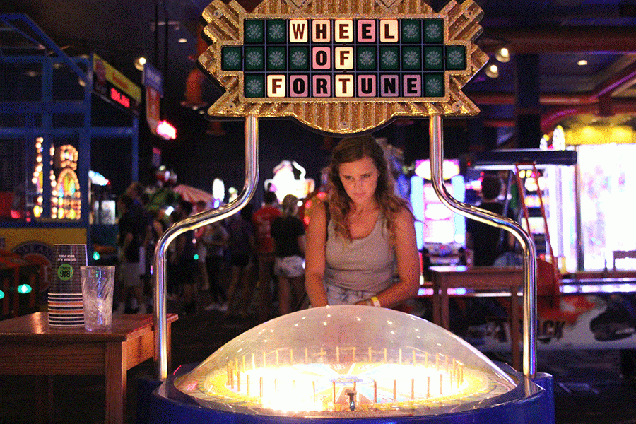 Attempting to hit the jackpot, junior Sydney Hanson plays Wheel of Fortune at after prom. 