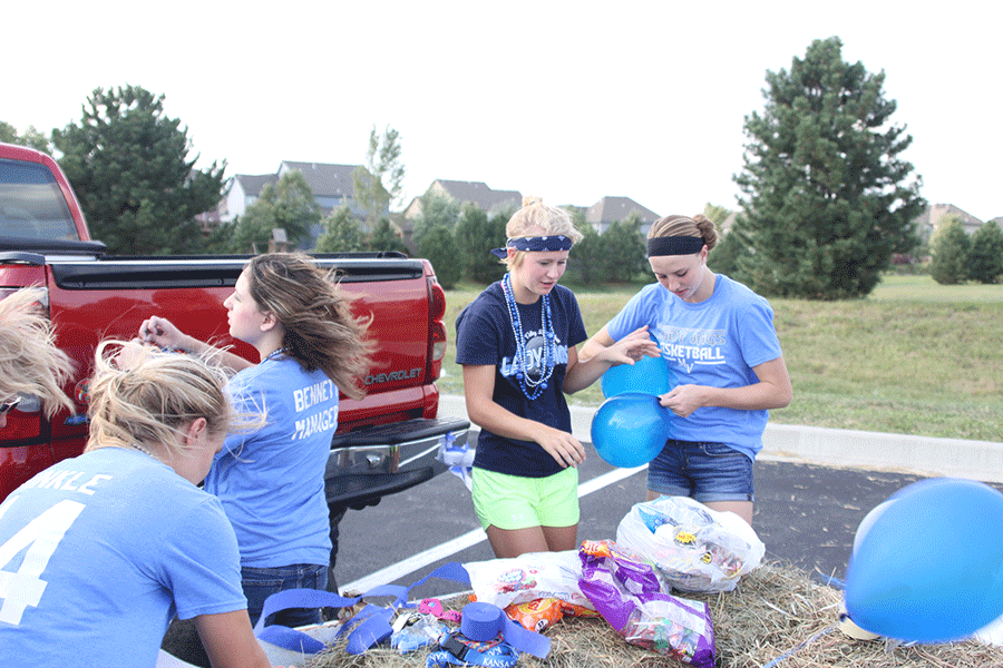 Junior Courtney Carlson and Sophomore Evan Zars work together whilst decorating the girls basketball float