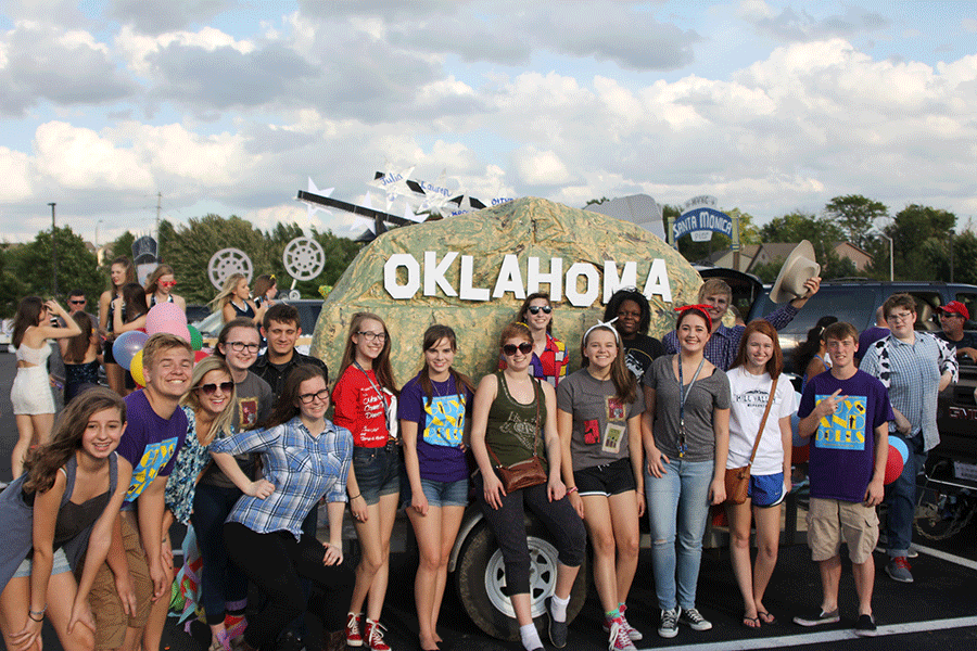 Musical cast poses in front of their Oklahoma themed float on Wednesday, Sept. 16.