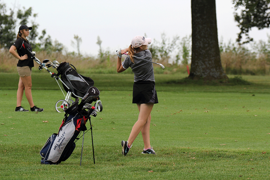 Following through with her swing, junior Grace Van Inwegen hits the ball onto the green on Tuesday, Sept. 8 at the Piper Invitational. Van Inwegen placed ninth with a total score of 99 and was pleased with the teams outcome of placing first. All members of the team placed in the top ten, resulting in their win.