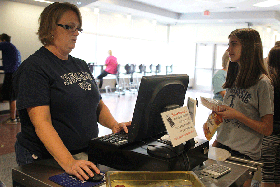 While on the register, lunch staff member Julie Rugenstein checks out a student’s meal on Tuesday, Sept. 8. “I still want to feel like a stay at home mom,” Rugenstein said. “This job makes it so I can.”