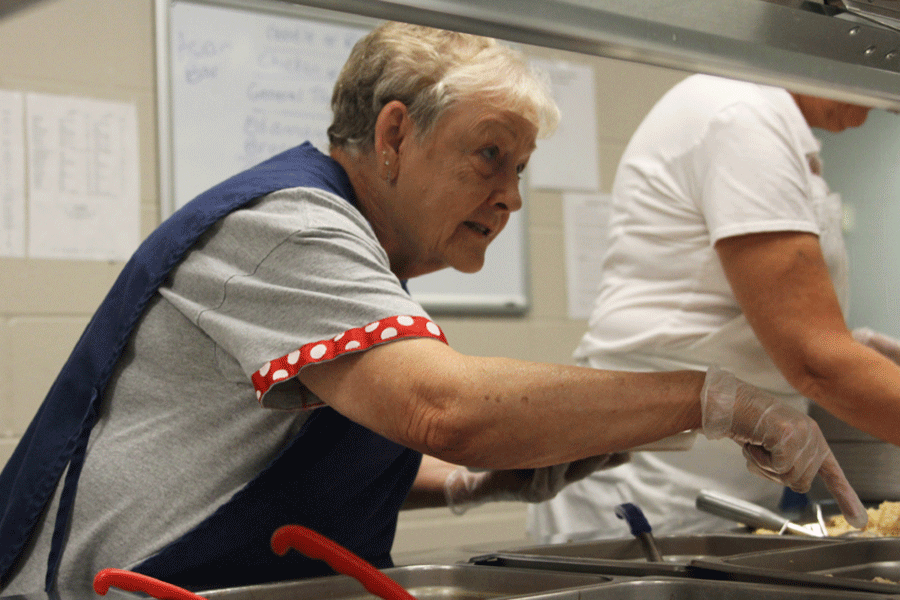 Lunch staff member Peggy Minter serves food on Tuesday, Sept. 8.