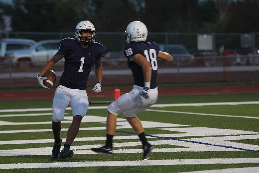 Senior Christian Jegen and sophomore Evan Rice prepare to chest bump after a touchdown by Jegen.