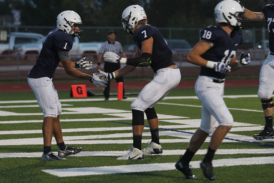 Seniors Christian Jegen and Lucas Krull shake hands after a touchdown by Jegen.