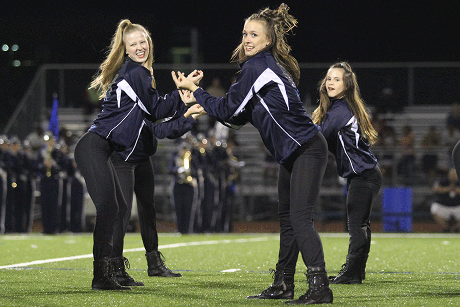 Junior Katherine Rouse and senior Natalie Golden perform along their fellow Silver Stars during half time.
