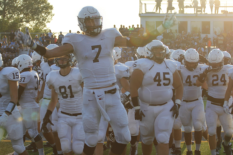 Following the coin toss, senior Lucas Krull gets fans excited before the game begins. The Jaguars defeated the Saints, 38-20, on Friday, Sept. 4, starting off their season with a record of 1-0.