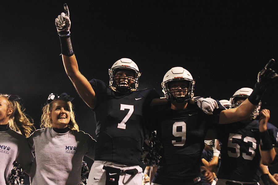 Seniors Lucas Krull and Cole Morris cheer alongside teammates and cheerleaders. The Jaguars defeated the Derby Panthers, 27-20, on Friday, Sept. 18.