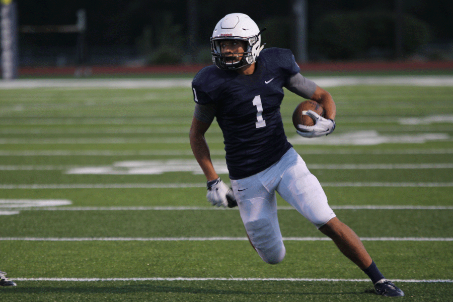 Senior Christian Jegen runs the ball during the football game against KC Southwest on Friday, Sept. 25.