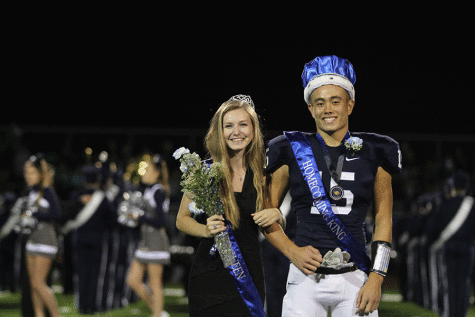 Seniors Megan Feuerborn and Chase Midyett stand arm in arm after being crowned Homecoming king and queen.