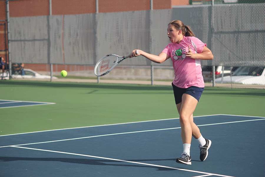Running towards the tennis ball, freshman Anika Roy plays in a tennis quad on Tuesday, Sept. 22. 
