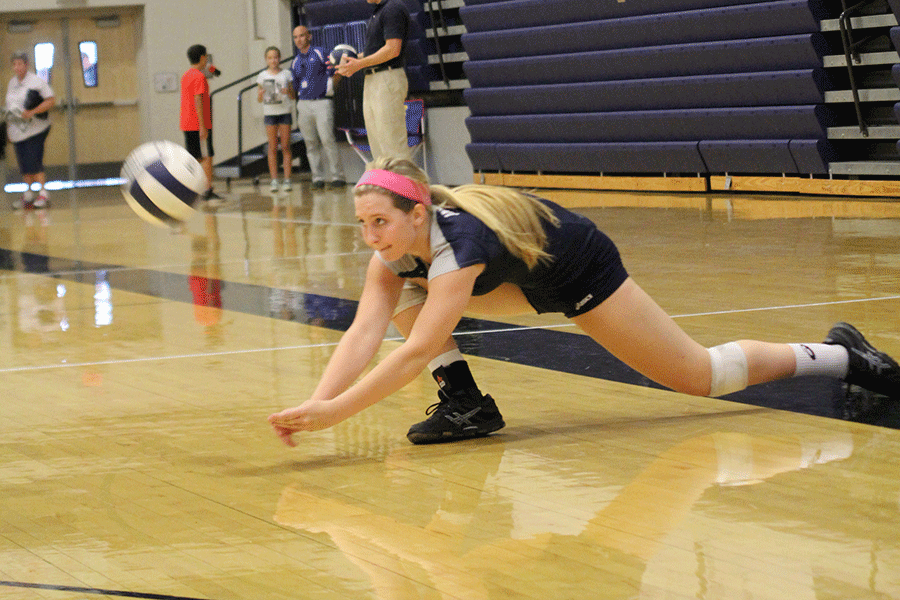 Sophomore Izzy Hellon dives for a ball.