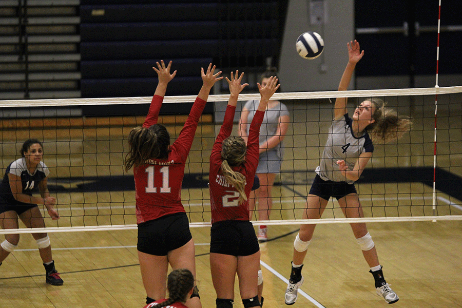 Hitting the ball over the net, junior Morgan Thomas scores a point. The team won against Tonganoxie in three games. We picked on their weak spots, but we made too many unforced errors, Thomas said. In practice, we are going to work hard so we can  win our tournament this weekend and KVL this season.