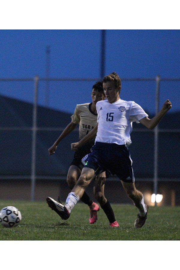 Freshman Jake Ashford passes the ball to get around his defender.