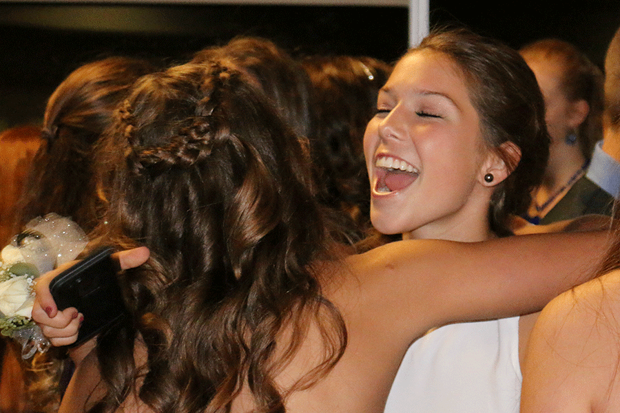 Freshman Lilli Milberger greets her friends at the Homecoming dance on Saturday, Sept. 19.